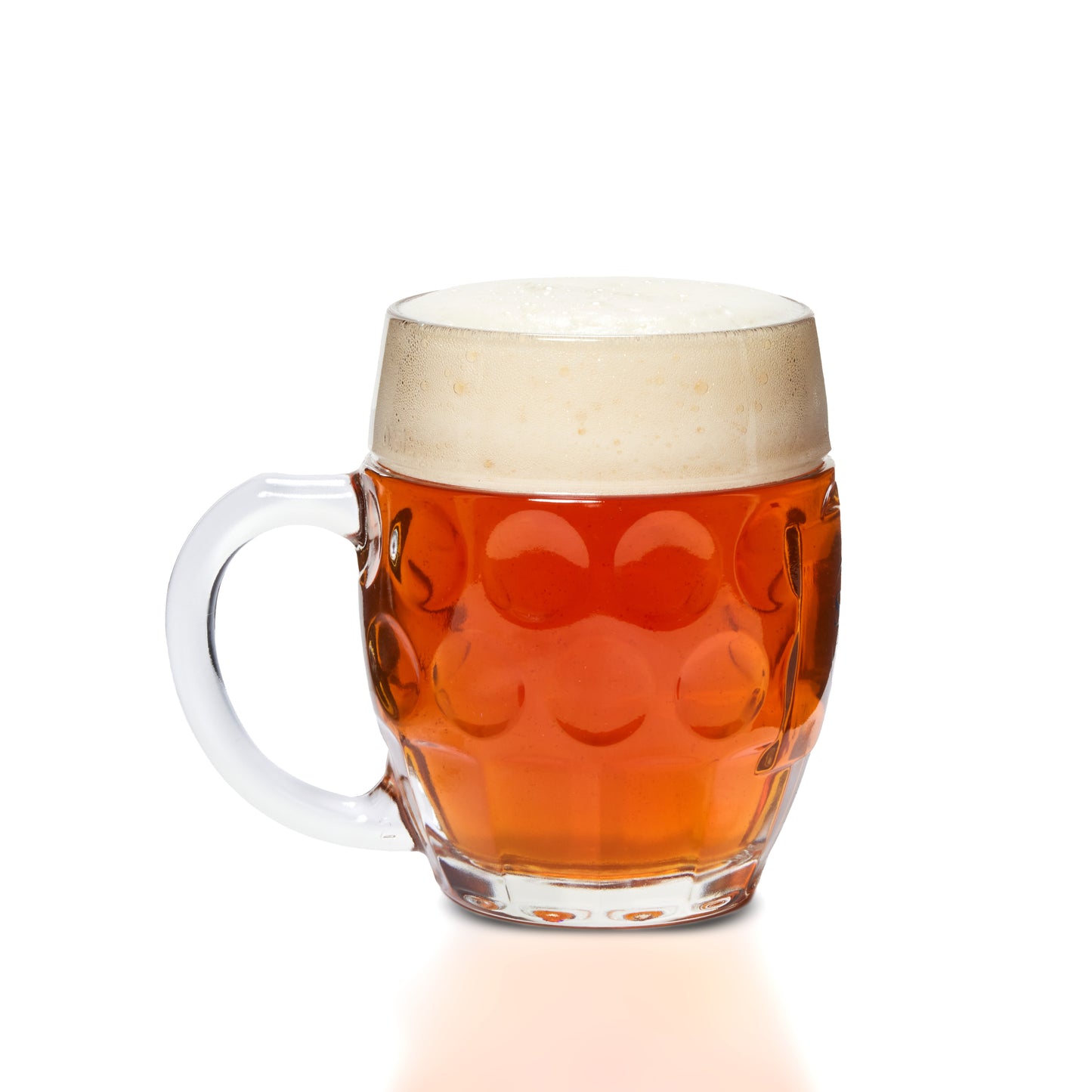 A clear glass beer mug with a handle, filled with amber beer and topped with a thick white foam head, photographed on a clean white background.