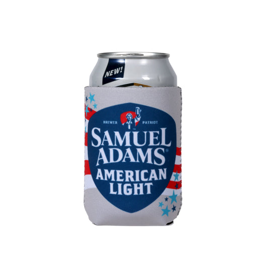 A grey 12 ounce can cooler with red and white stripes going across it and light and dark blue stars around the edges, with a dark blue shield with the Samuel Adams and American Light beer logos inside it.