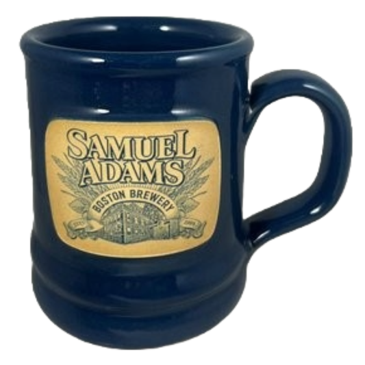A navy blue ceramic mug with the Samuel Adams Boston Brewery design on the front.