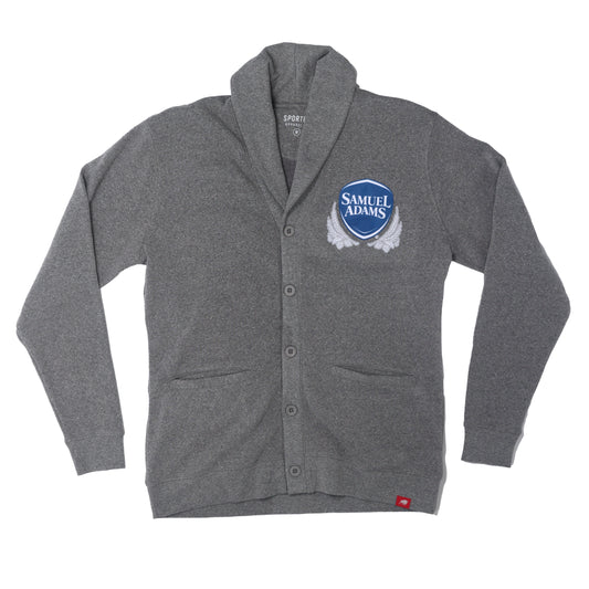 A Grey Henshaw Cardigan with button closures on the front and the classic Samuel Adams shield logo on the top left in navy and white.