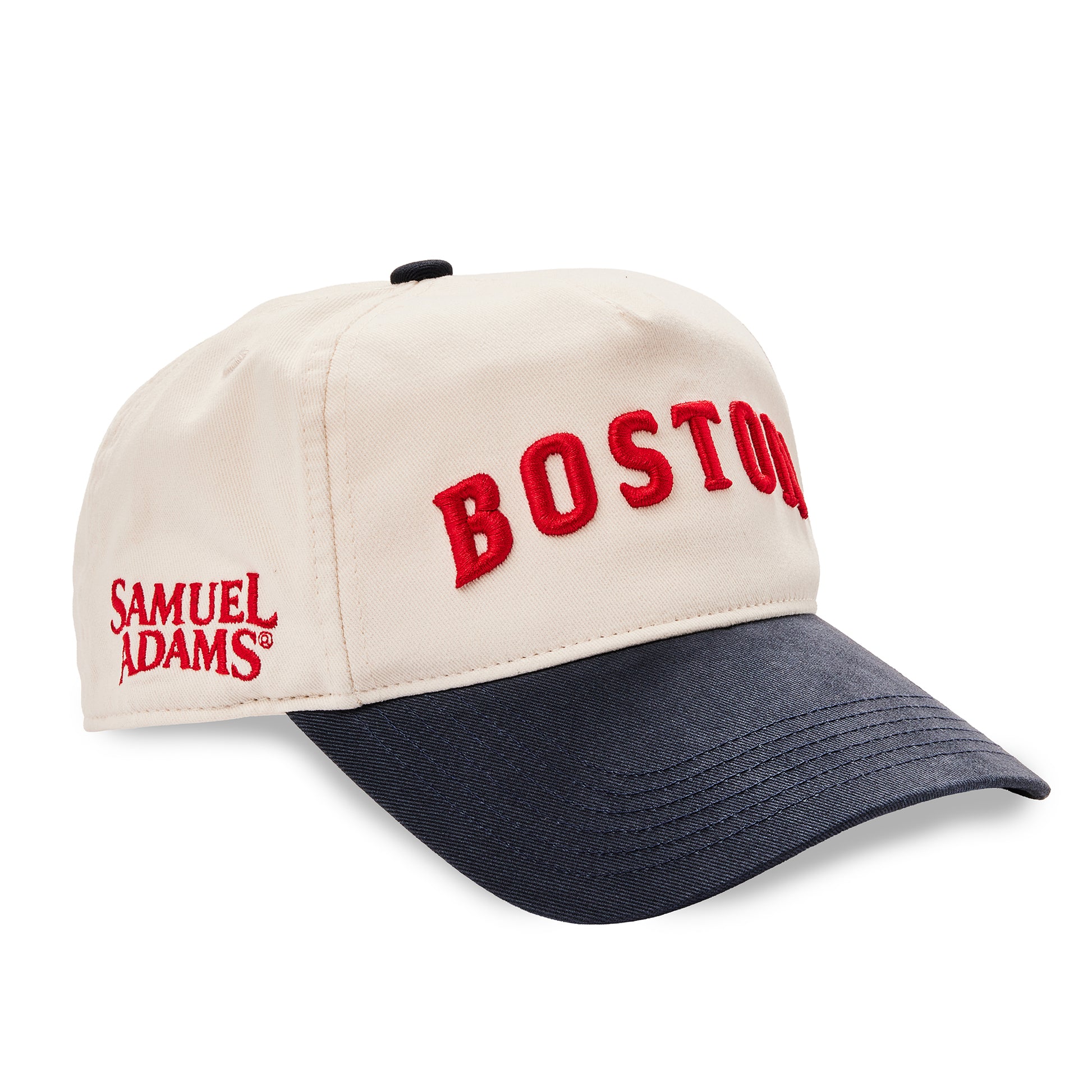 A baseball cap with an off-white crown, navy blue brim, and red embroidered text reading 'BOSTON' and 'SAMUEL ADAMS'.