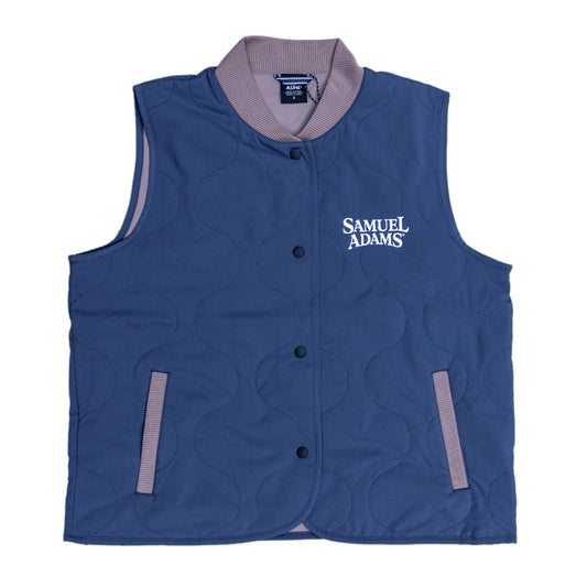 Front view of the navy quilted vest. The collar, pocket lining, and inside of the vest are gray. The Samuel Adams logo in white is featured on the left side of the chest.