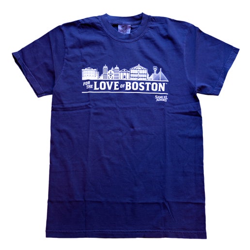 Front view of blue tee features imagery of the Boston skyline and writing "For the Love of Boston" with the Samuel Adams under it, all in white.