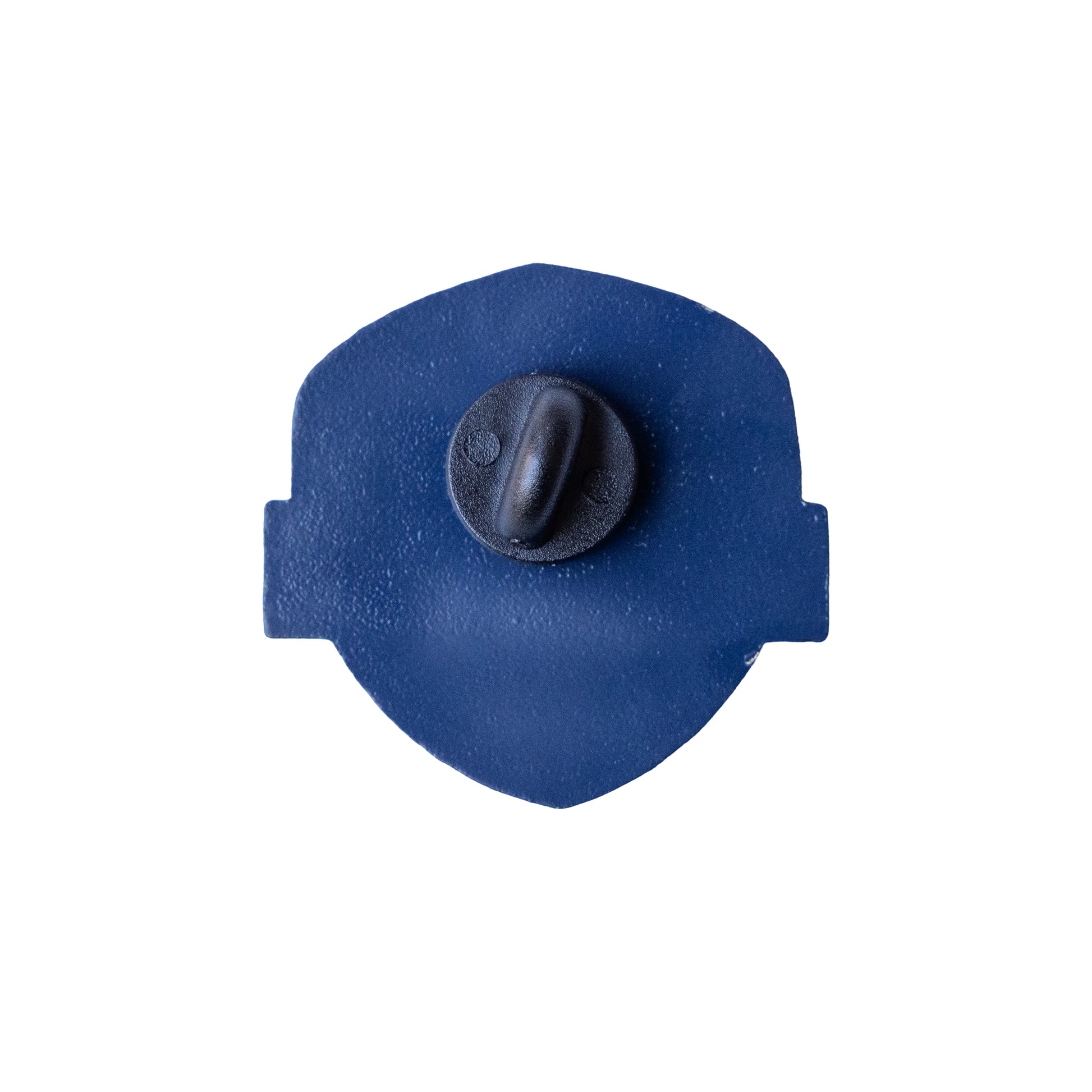 Back view of Samuel Adams enamel pin showing solid navy blue metal backing with single black rubber clutch fastener and smooth shield‑shaped silhouette