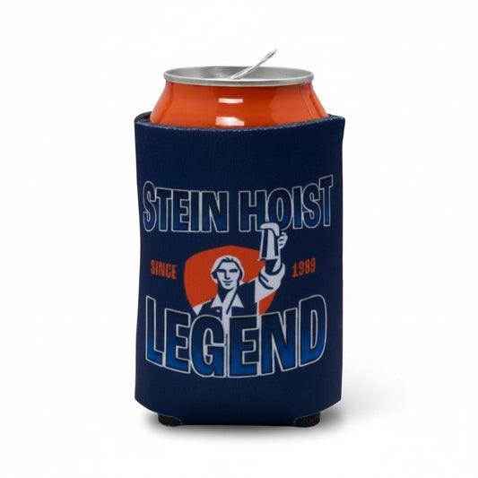 A navy blue neoprene can cooler sleeve holding an orange beverage can, featuring a graphic of a man holding a beer mug with the text 'STEIN HOIST LEGEND' and 'SINCE 1989' on a white background.