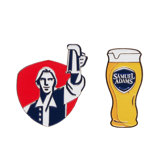 Close-up of Samuel Adams golf ball markers set showing Boston Lager beer glass design and Samuel Adams hoist logo 