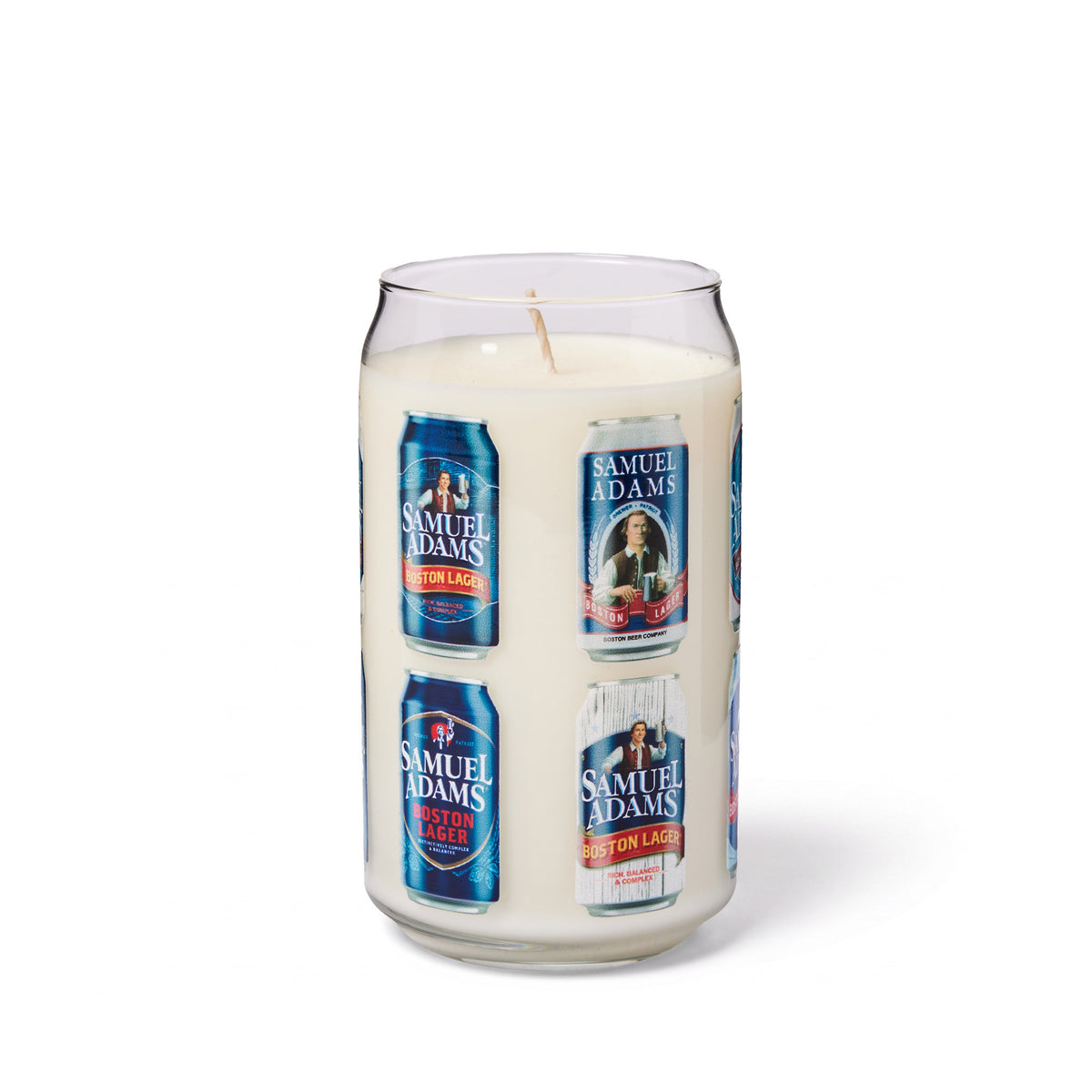 A novelty candle in a clear glass shaped like  Samuel Adams beer can, filled with white wax and featuring printed labels of  Samuel Adams Boston Lager craft beers cans around the circumference of the glass. Set on a white background