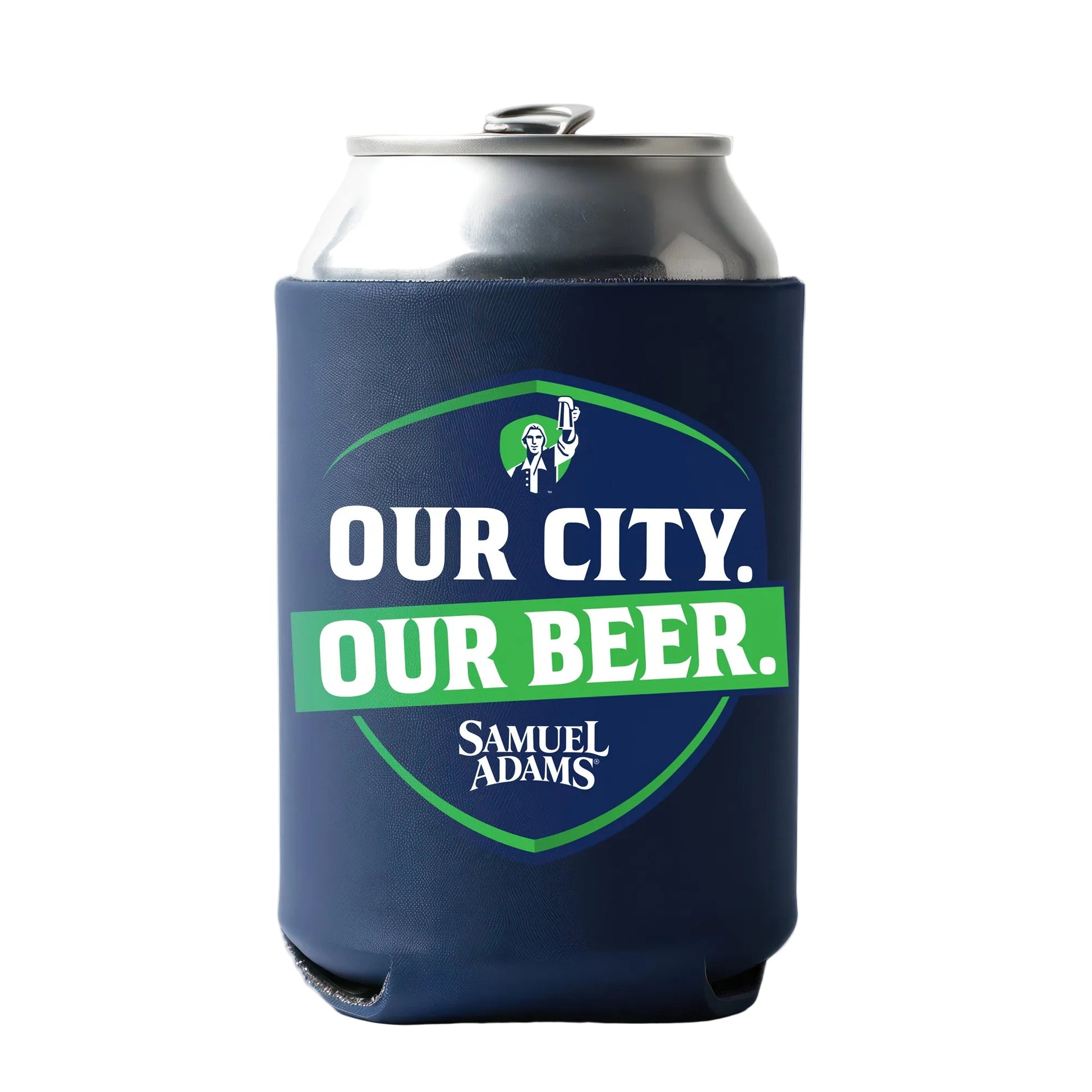 A silver beverage can enclosed in a navy blue can cooler displaying a large shield‑shaped emblem. At the top of the shield is the Samuel Adams hoist figure icon illustrated in white and green. Bold white text reads “OUR CITY.” above a bright green banner with “OUR BEER.” in white letters. The Samuel Adams logo sits below the banner, and the overall design incorporates green accents to match the Derrick White theme. 