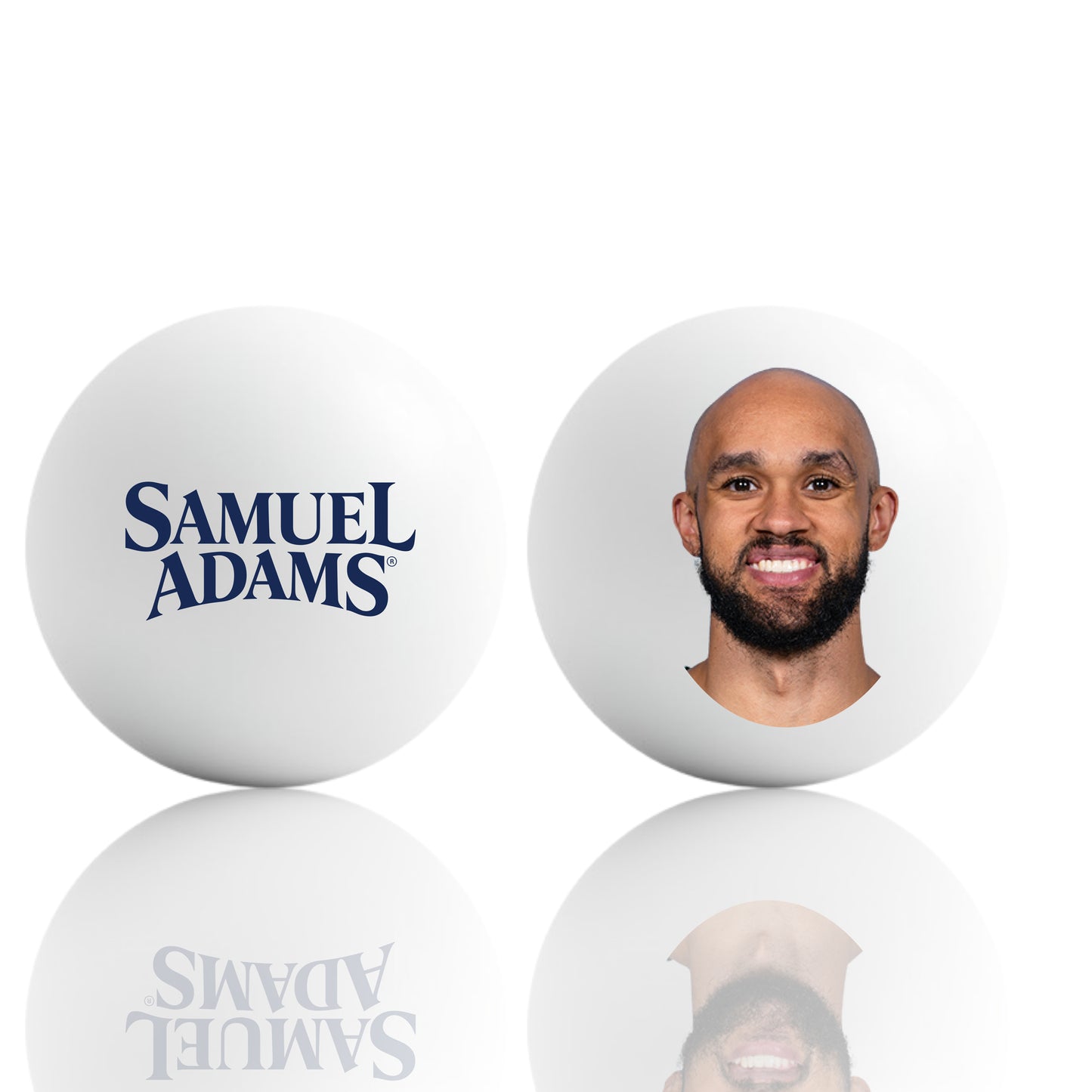 A pair of white ping pong balls displayed side‑by‑side on a reflective surface. The ball on the left shows the Samuel Adams logo in bold navy lettering. The ball on the right features a centered Derrick White headshot, printed cleanly on the smooth white surface.