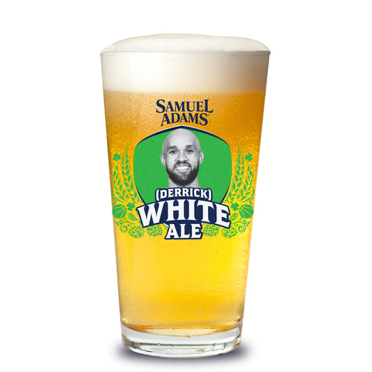 Filled pint glass with a Samuel Adams logo and a limited edition Derrick White Ale shield logo, stylized in navy and green 