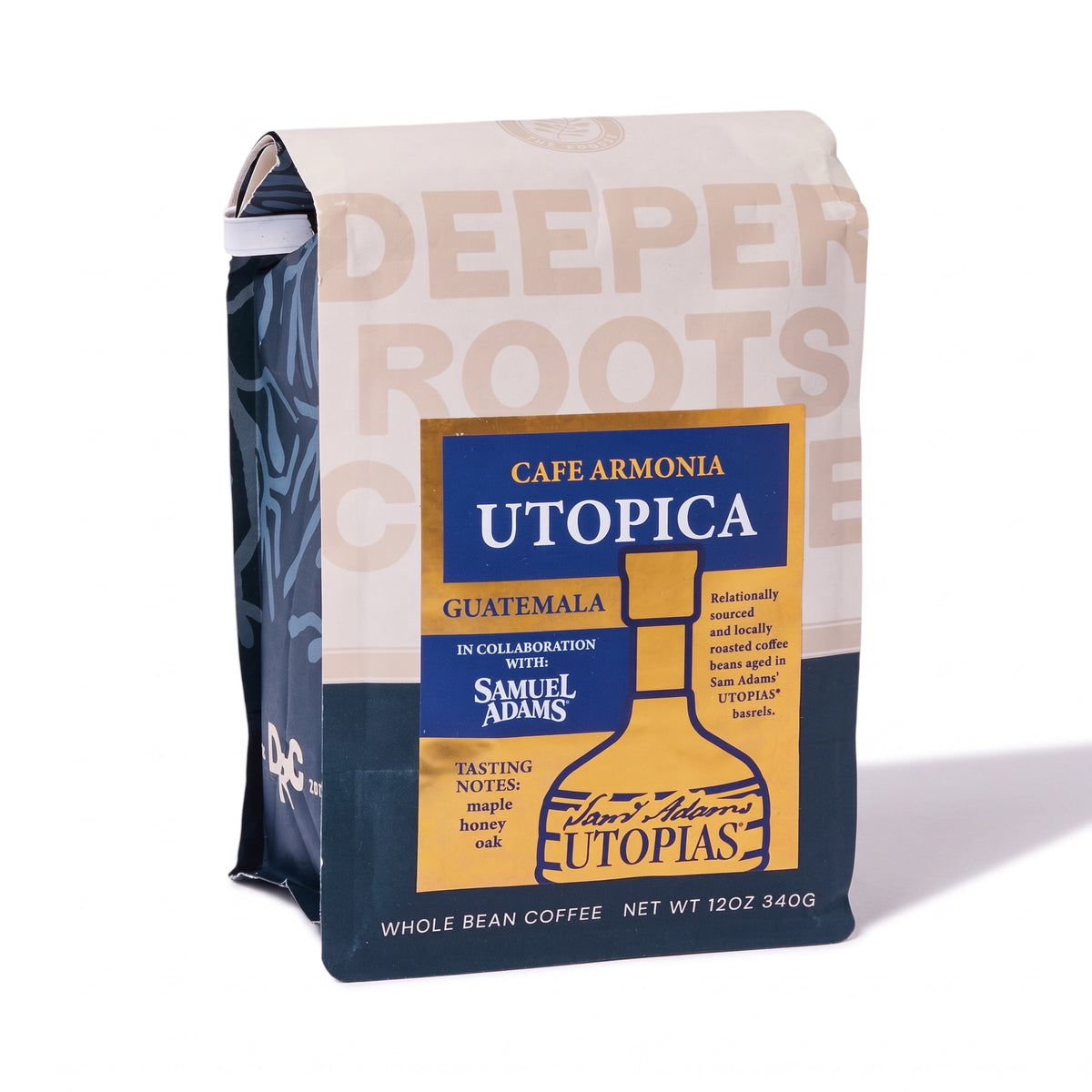 A bag of Cafe Armonia Utopia whole bean coffee, featuring a cream and navy blue design with a central gold label depicting a coffee bottle and the Samuel Adams Utopias logo.