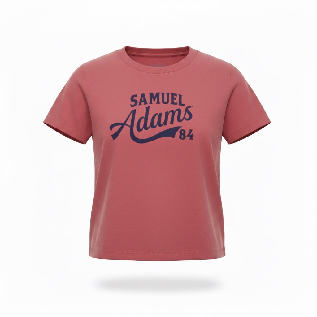 A pale red tee shirt against a white background. "Samuel Adams 84" is written in a blue sport logo font across the front. 