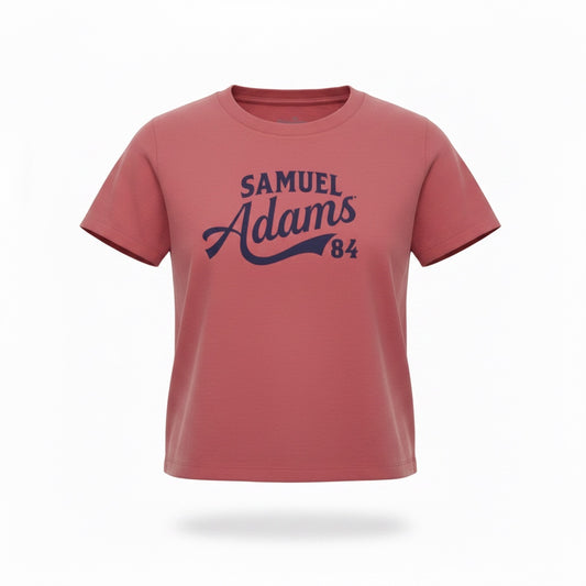 A pale red tee shirt against a white background. "Samuel Adams 84" is written in a blue sport logo font across the front. 