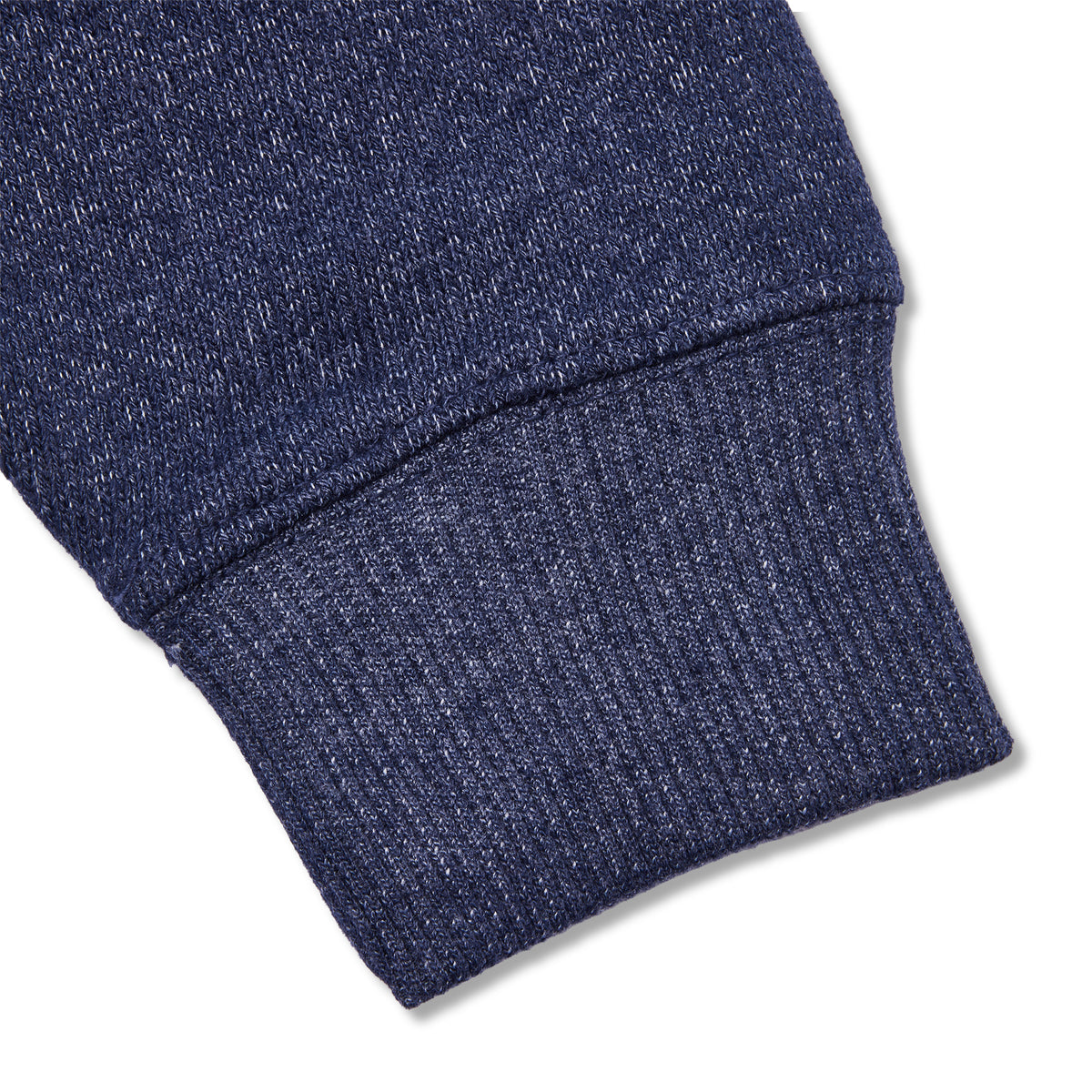 Close-up of a navy blue ribbed knit fabric cuff, showing the texture and construction detail against a white background.