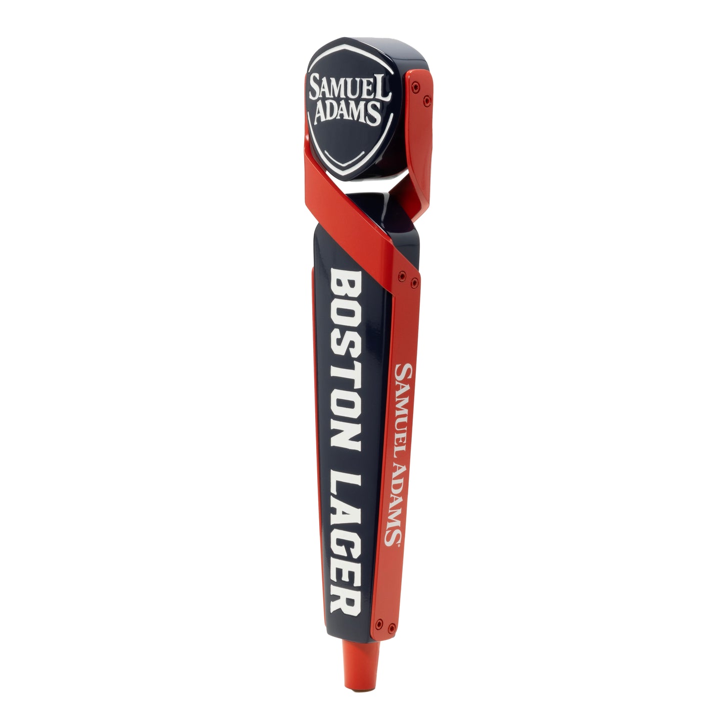 A tap handle with the Sam Adams logo written in white against a blue shield shaped piece. The shield is being held by two red shapes that cross and wrap around the edges of the tap handle.  Boston Lager is written vertically in white across the blue body of the tap handle. Sam Adams logo is written vertically in white on the red part of the tap handle. There is a red cylindrical shape at the bottom. 
