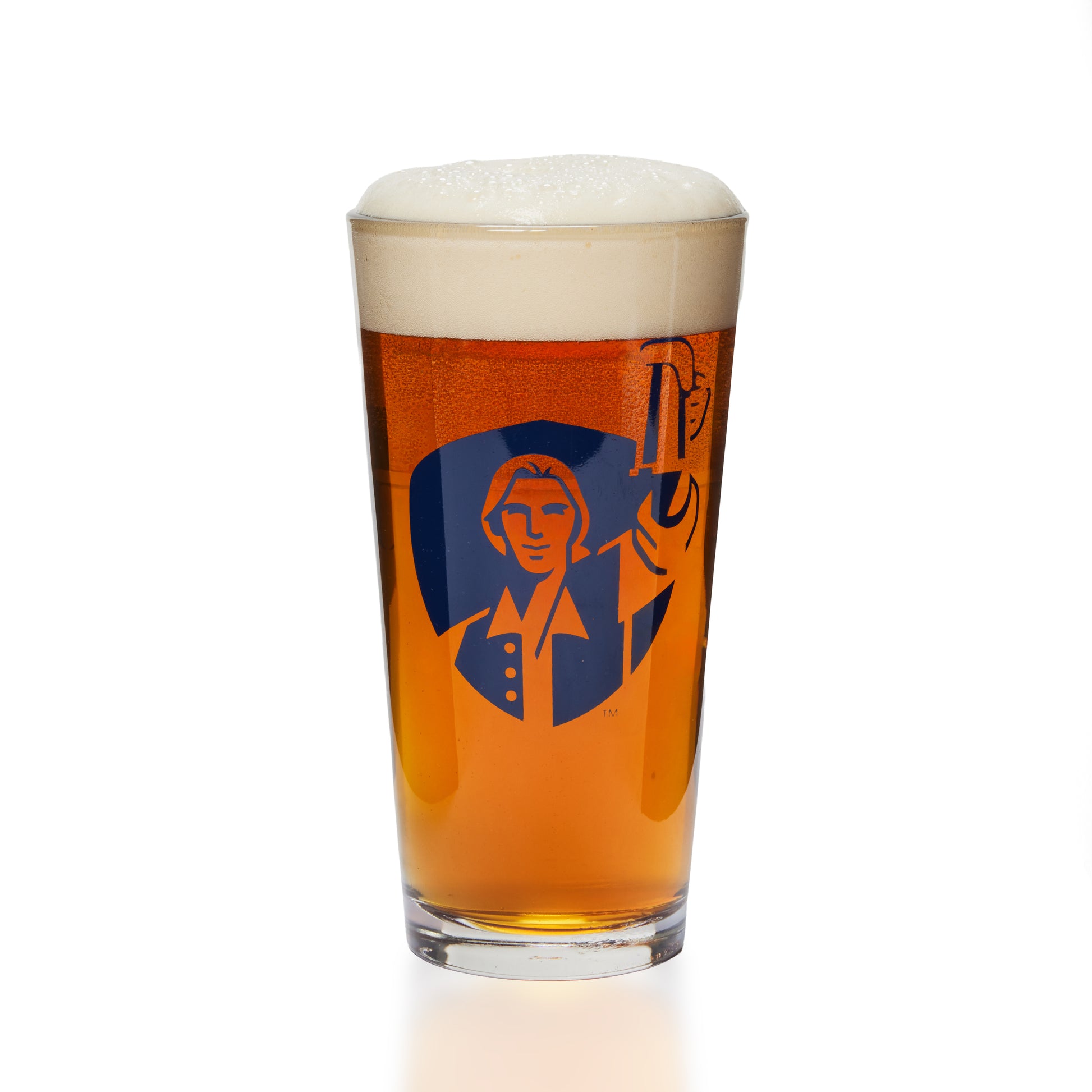 A pint glass filled with amber beer and topped with white foam, featuring a blue graphic of a man holding a beer mug on the front, set against a plain white background.