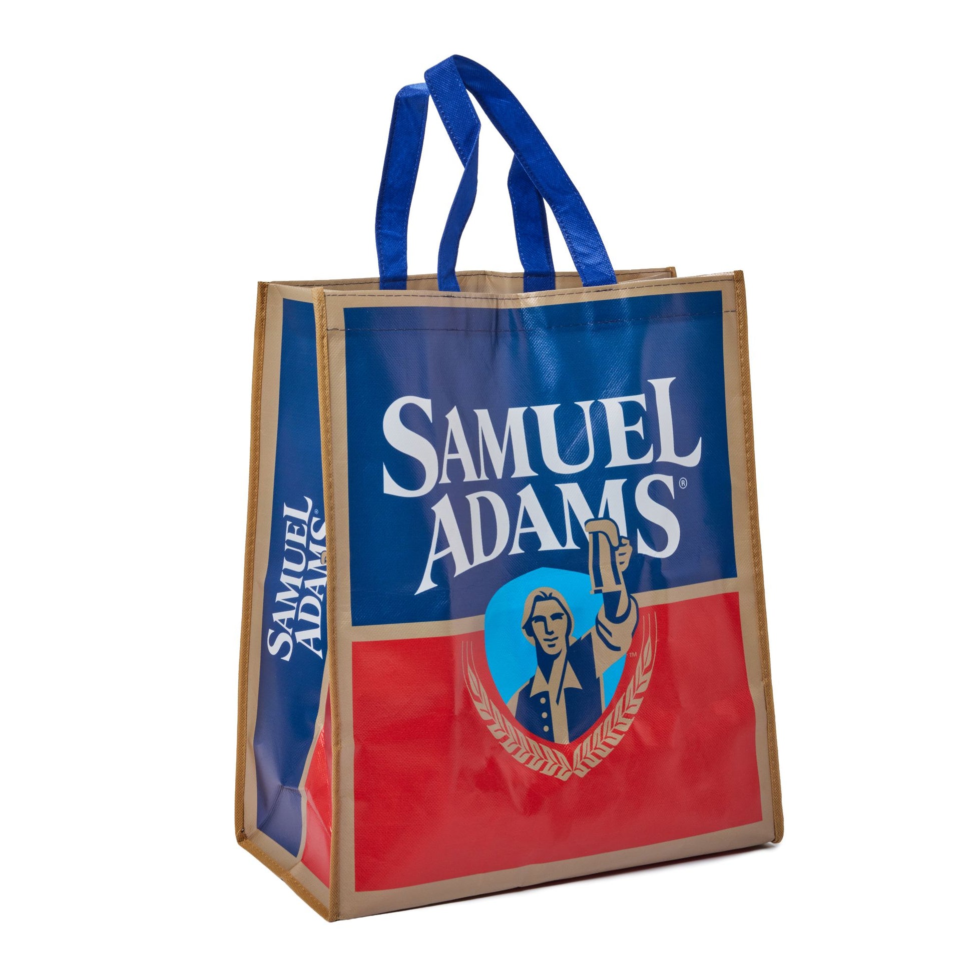 A reusable Samuel Adams tote bag with blue handles, featuring a blue and red printed design with the Samuel Adams logo and illustration on a white background.