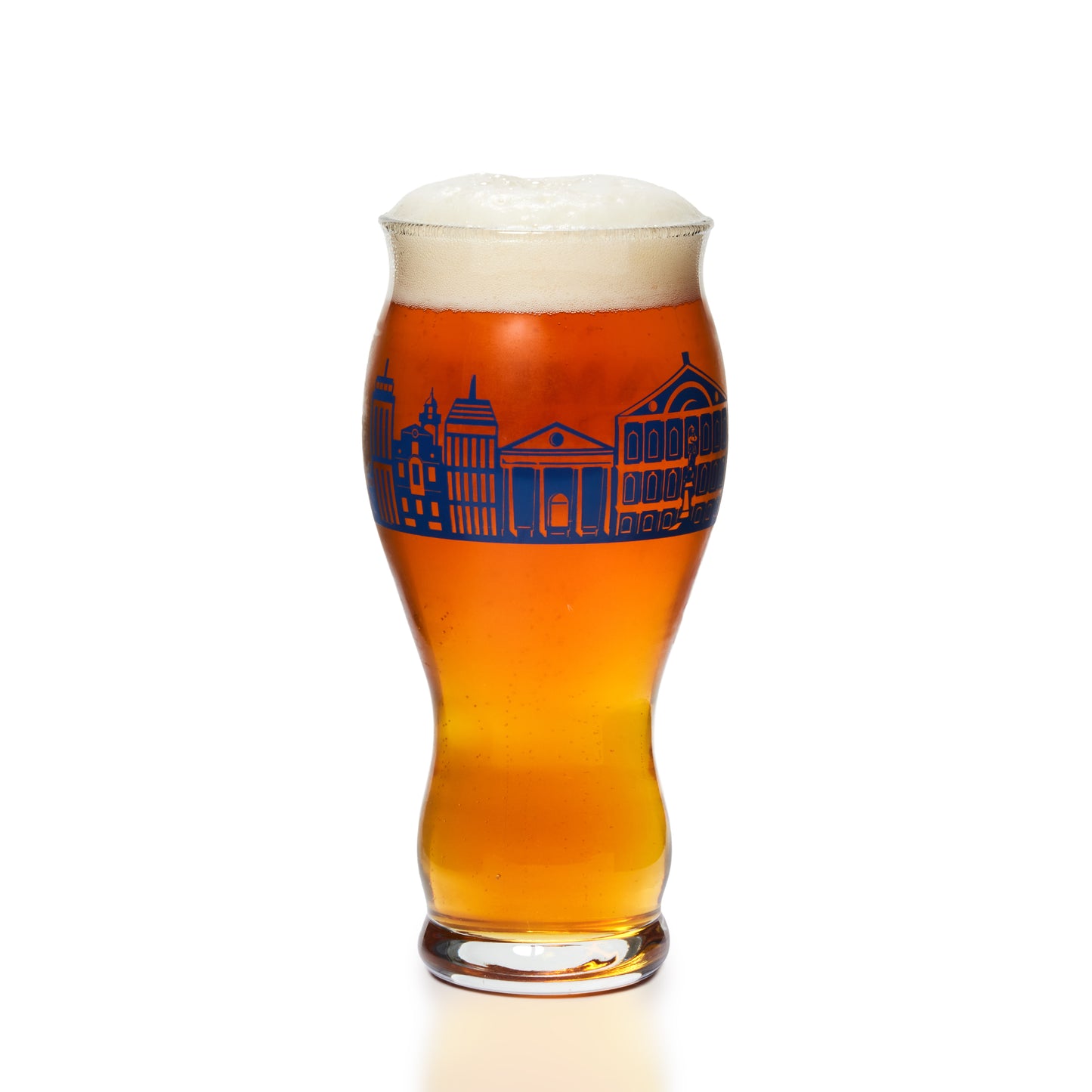 A tulip-shaped glass of amber beer with a white head of foam, featuring a blue architectural skyline graphic on the front, isolated on a white background.