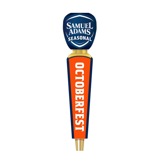 A Samuel Adams Seasonal Octoberfest beer tap handle on a plain white background. The handle features a dark blue top with white text, a gold collar, and a bright orange body with 'OCTOBERFEST' printed vertically in white.