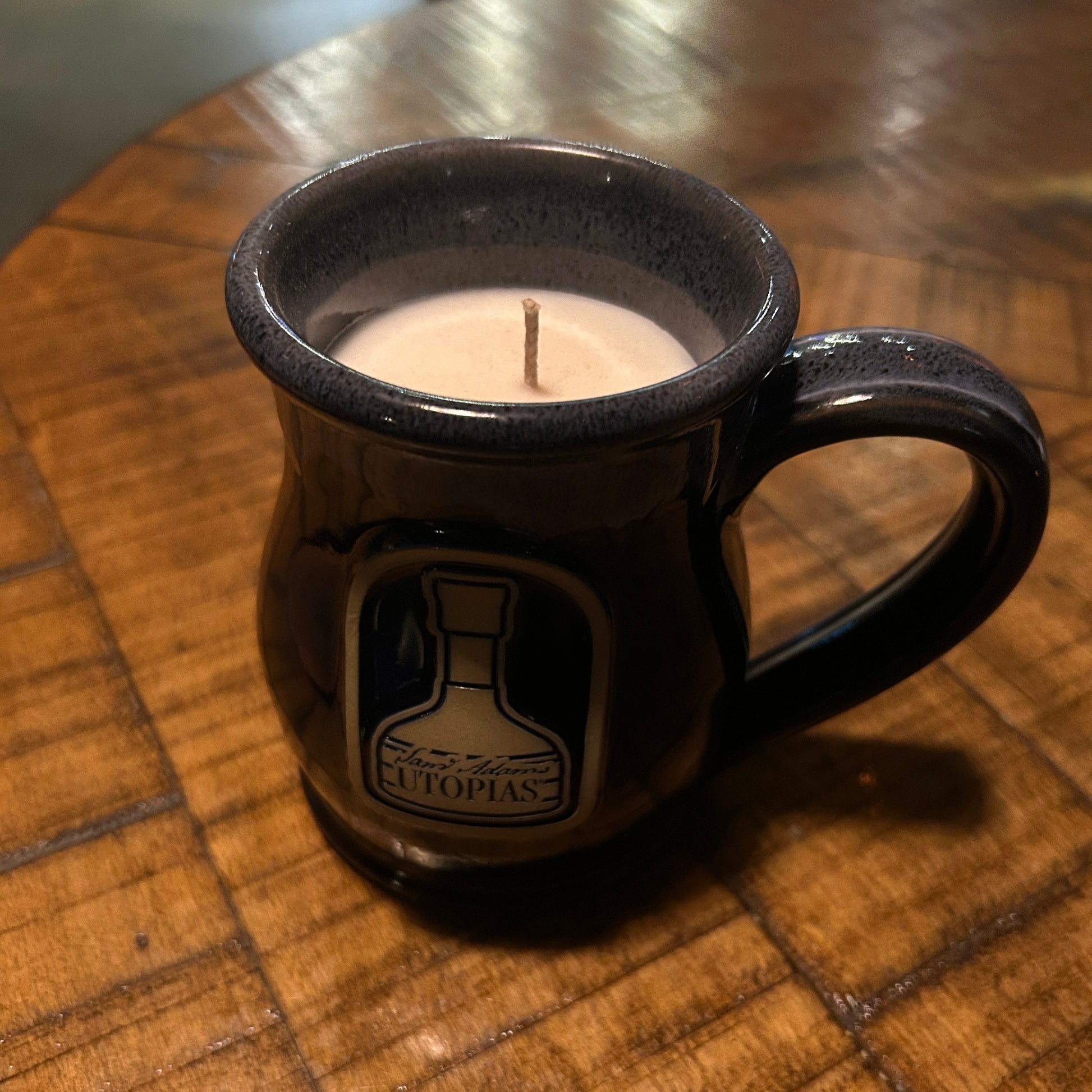 Utopias ceramic mug candle with a sam adams utopias designed on it. 