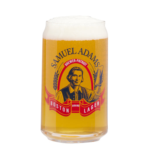 Front view of can glass with beer filled to the brim. Glass features Sam Adams hoisting a beer with writing "Samuel Adams Boston Lager" and "Brewer Patriot" around him.