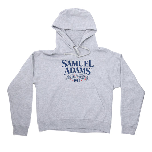 Women's heather Grey CHAMPION 1984 Hoodie with the Samuel Adams logo across the front in navy.