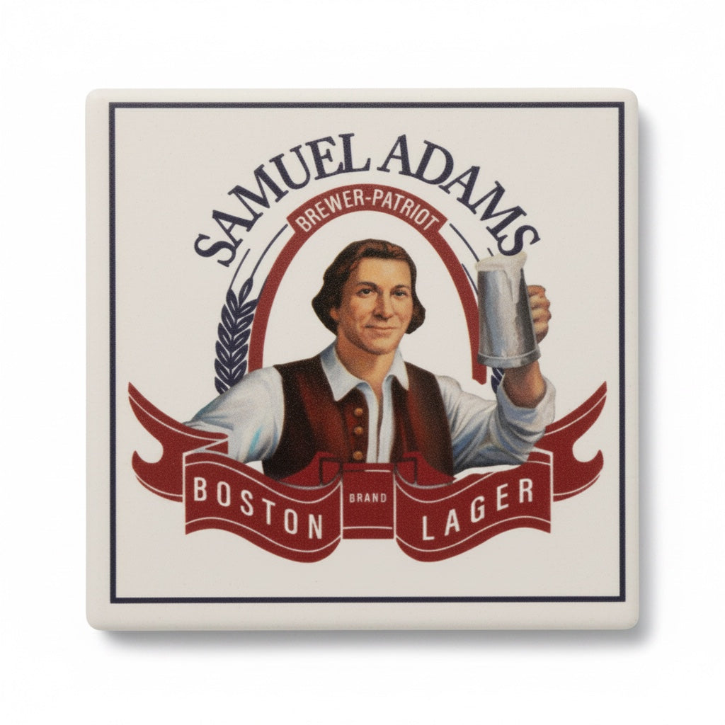 a top view of a coaster, with curved Sam Adams text at the top, "Brewer Patriot" written underneath the top text. Featuring a colonial dressed person raising a stein. "Boston Lager" is written in white within in a flag shape at the bottom. 